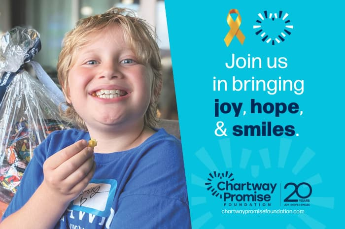 A child in a blue shirt smiling