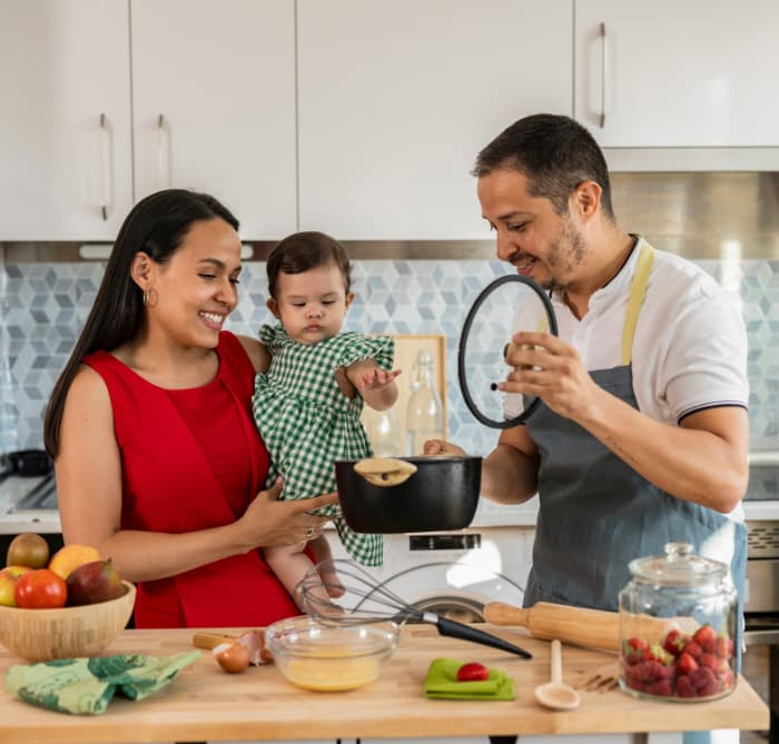 beautiful Latin American family preparing delicious food in the kitchen