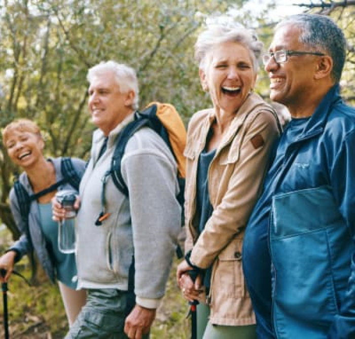 Elderly friends hiking on a trail