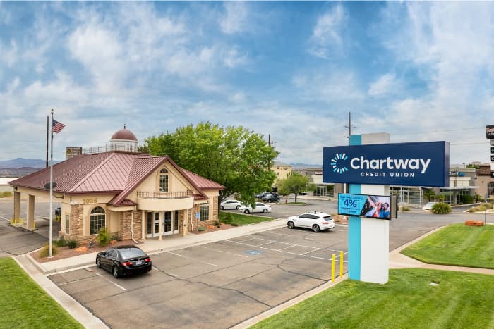 a credit union building with a red gabled roof