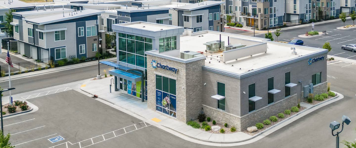 grey Chartway building on a street corner surrounded by other buildings