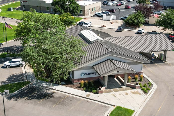 a Chartway Credit Union building with trees standing on the left side