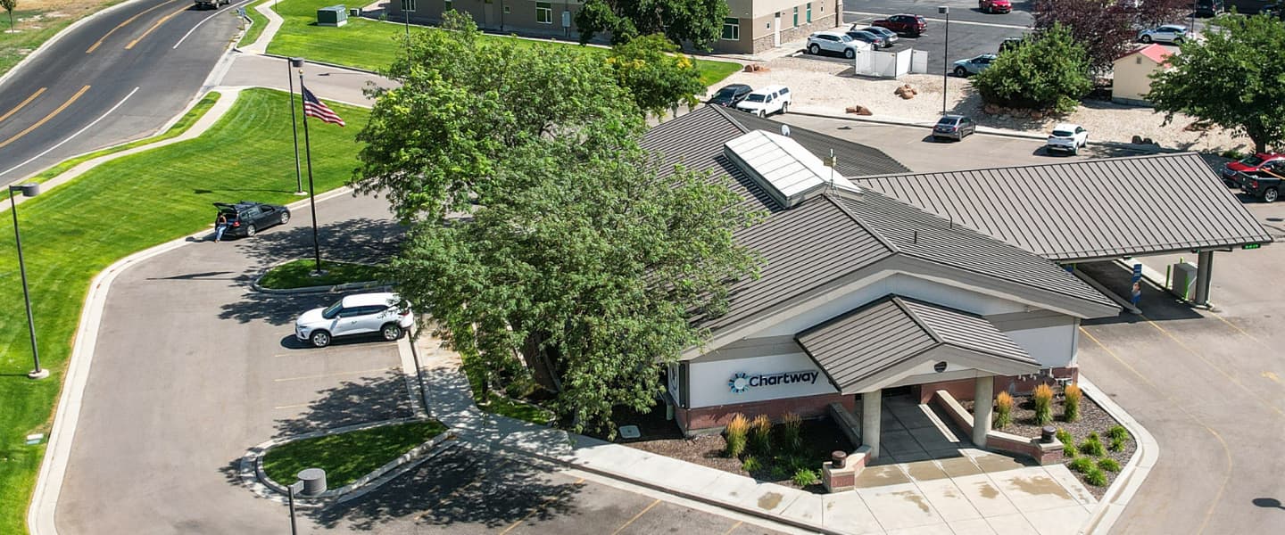 a Chartway Credit Union building with trees standing on the left side