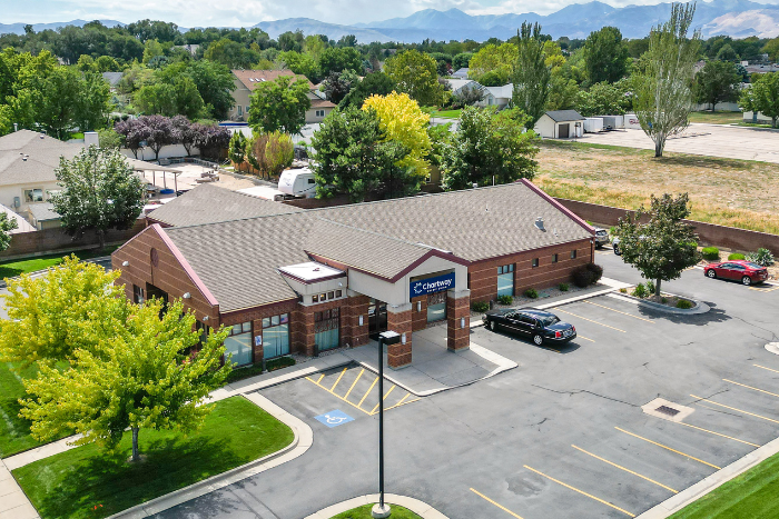 a red brick Chartway Credit Union building with a parking lot out front