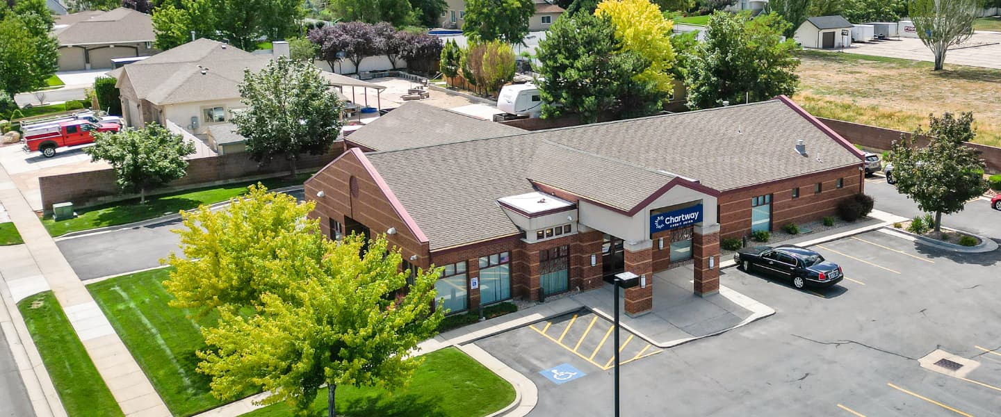 a red brick Chartway Credit Union building with a parking lot out front